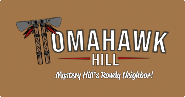 Logo for Tomahawk Hill featuring two crossed tomahawks on a brown background, with the tagline Mystery Hill’s Rowdy Neighbor! written below the main title.